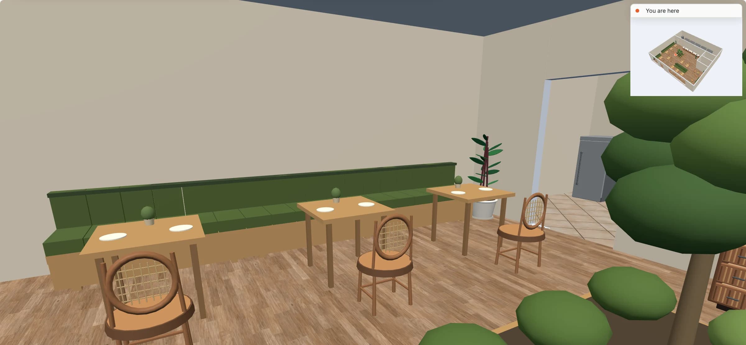 Walkthrough at eye height: a long green banquette with oak tables and cane chairs, a plant, the kitchen doorway, and a small overview map of the room